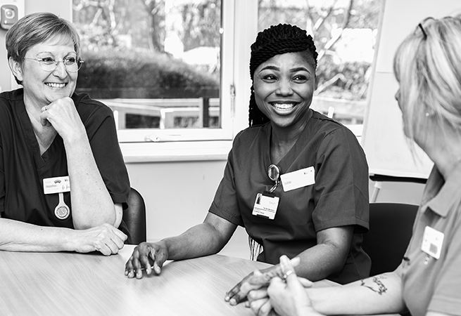Elysium Healthcare nurses sat around a table.