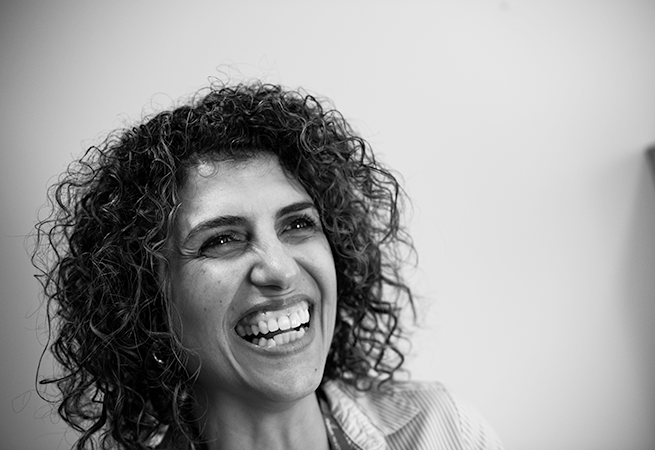 Black and white image of female Elysium Healthcare employee smiling