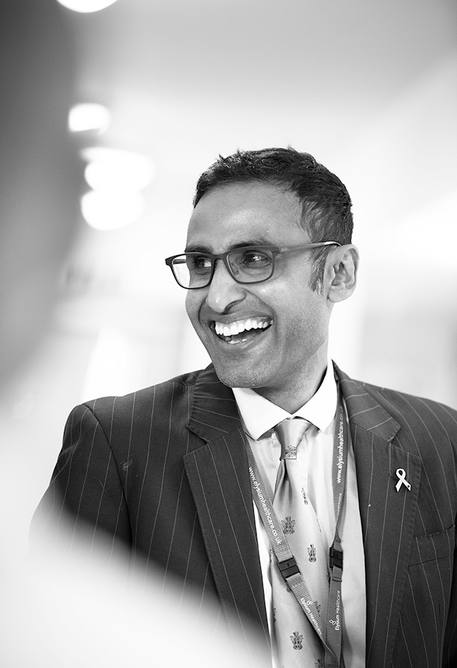 Medical Director in psychiatry, Neel Holder smiling in black and white photo