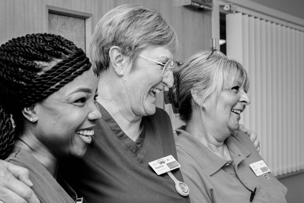 Group of healthcare staff smiling.